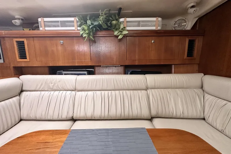 Slide: The Image of Luxurious interior of a 2002 Hunter 466 yacht with plush seating and wooden cabinetry. - 17