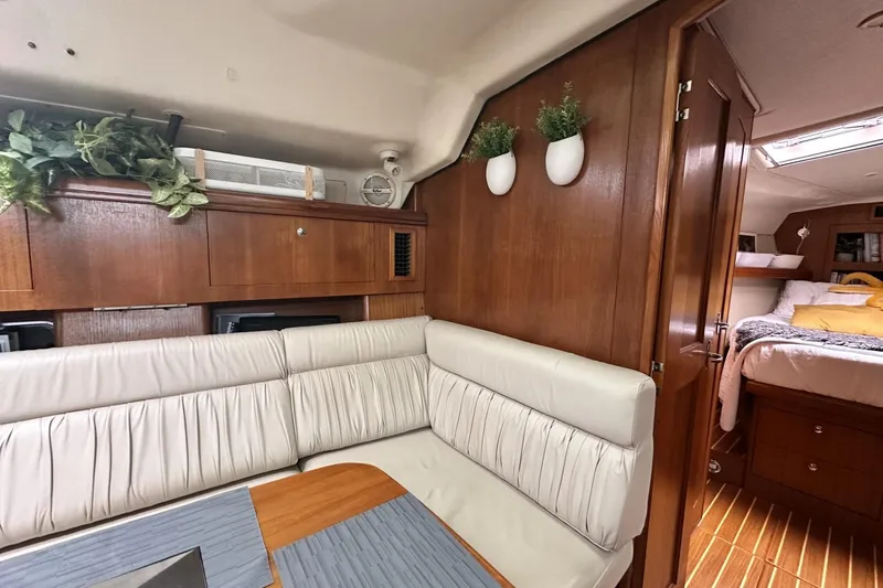 Slide: The Image of Interior of 2002 Hunter 466 yacht with cozy seating and wooden cabinetry. - 18