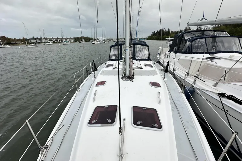 Slide: The Image of Sailboat Hunter 466 (2002) docked in a marina, surrounded by calm waters. - 2