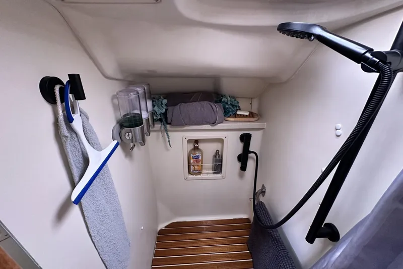 Slide: The Image of Compact bathroom in a 2002 Hunter 466 yacht with shower and storage. - 24