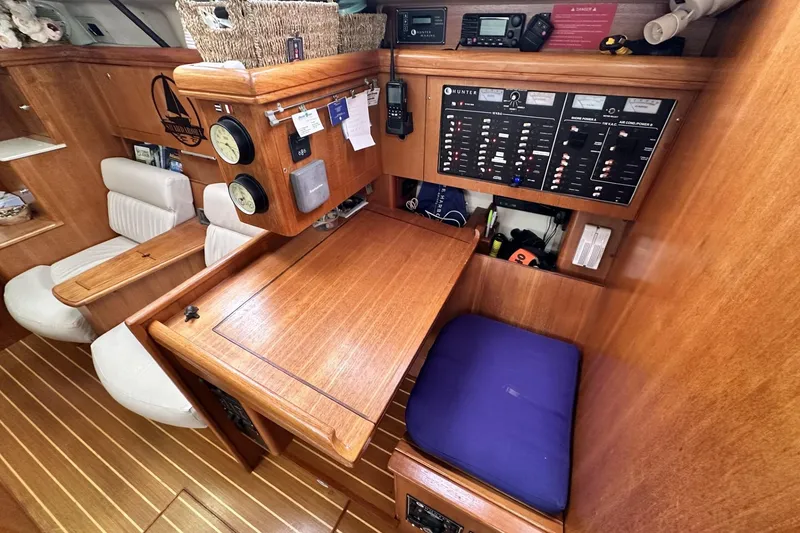 Slide: The Image of Interior of a 2002 Hunter 466 sailboat with navigation station and control panels. - 28