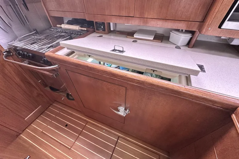 Slide: The Image of Wooden galley kitchen in 2002 Hunter 466 yacht with stove and storage. - 36