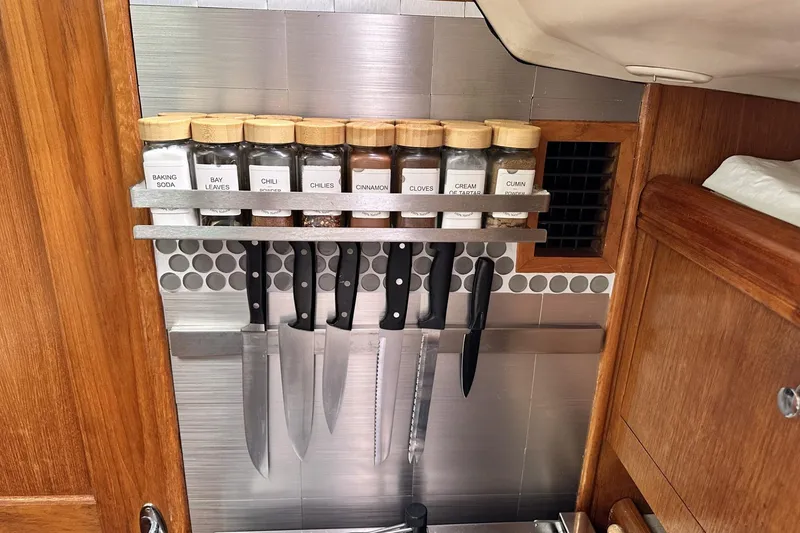 Slide: The Image of Spice rack and knives in a 2002 Hunter 466 boat kitchen. - 41