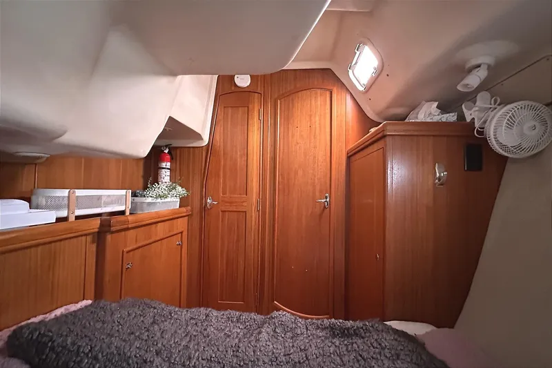 Slide: The Image of Interior of a 2002 Hunter 466 yacht with wooden furnishings. - 45