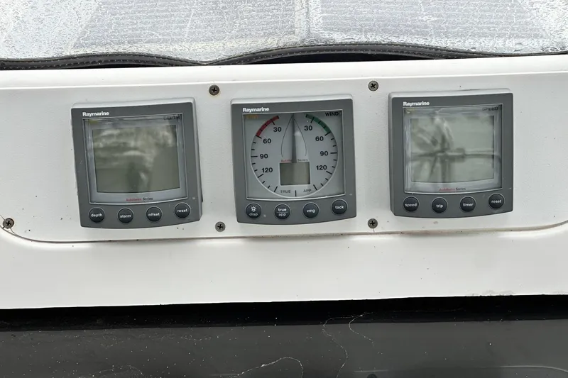 Slide: The Image of Raymarine navigation instruments on a 2002 Hunter 466 sailboat dashboard. - 51