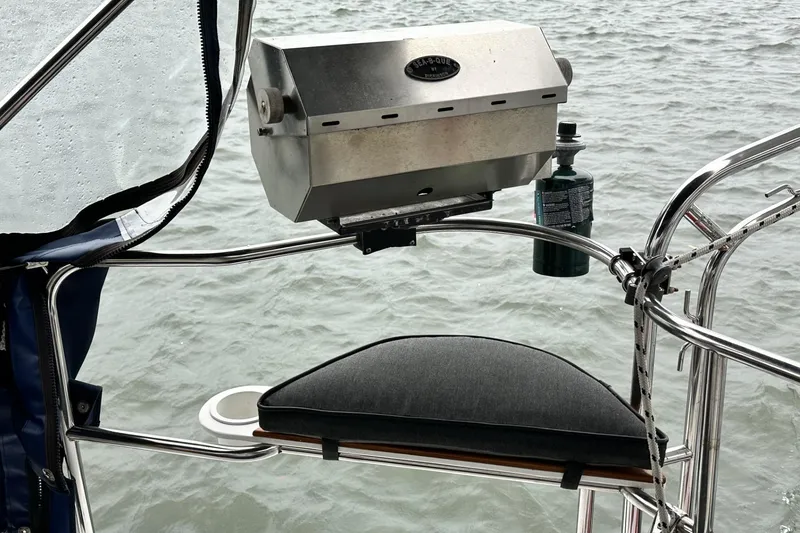 Slide: The Image of Outdoor grill setup on a 2002 Hunter 466 sailboat, overlooking water. - 52