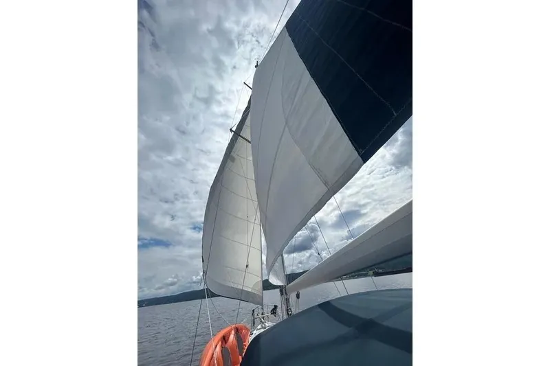 Slide: The Image of Sailing on a 2002 Hunter 466 yacht under cloudy skies. - 55