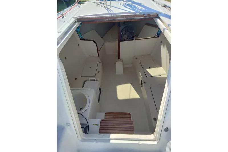 The Image of Interior view of a 1998 Hunter 240 sailboat cabin with seating and storage. - 1