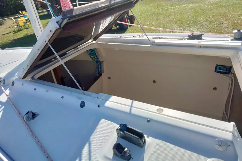 Slide: The Image of Open hatch on a 1998 Hunter 240 sailboat, showing interior storage space. - 13
