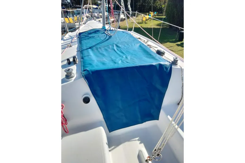 Slide: The Image of Hunter 240 sailboat deck with blue cover, 1998 model, docked outdoors. - 14