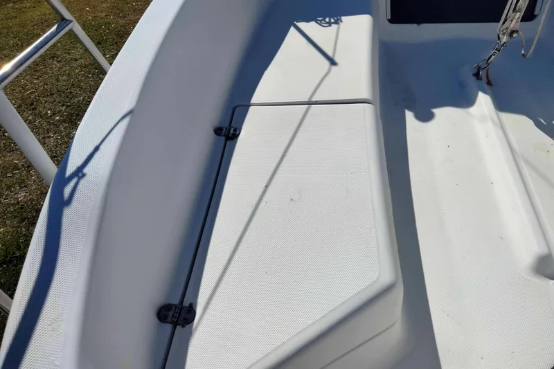 Slide: The Image of Deck of a 1998 Hunter 240 sailboat, featuring clean white surfaces and hardware. - 24