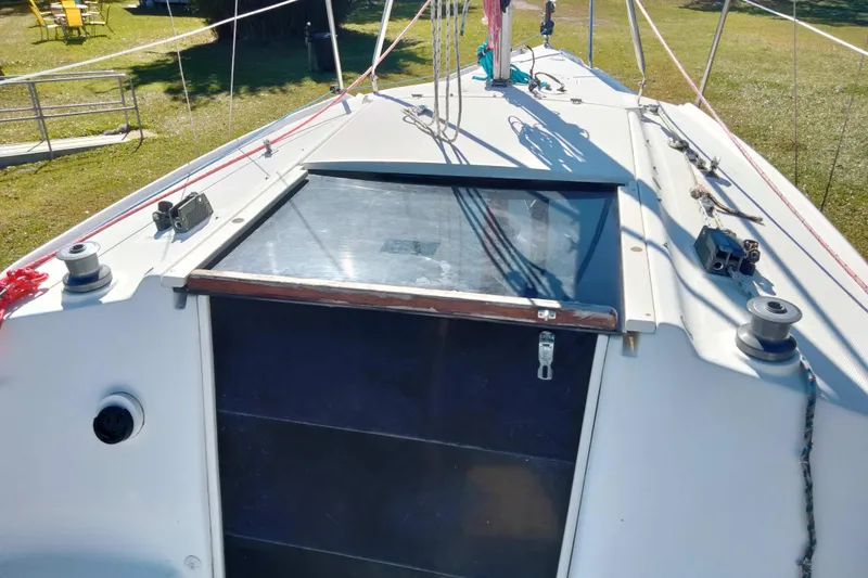 Slide: The Image of Hunter 240 sailboat deck, 1998 model, featuring hatch and rigging in a grassy setting. - 26