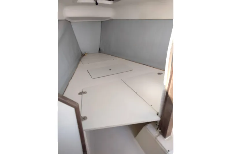 Slide: The Image of Interior cabin of a 1998 Hunter 240 sailboat, featuring a compact sleeping area. - 3