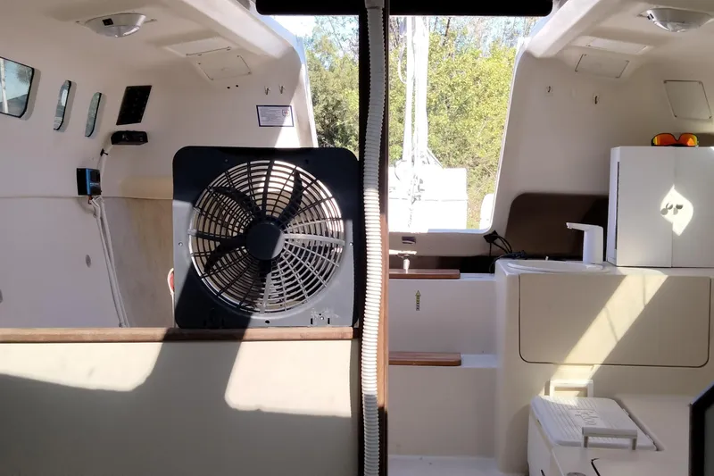 Slide: The Image of Interior of a 1998 Hunter 240 sailboat featuring a fan and compact kitchenette. - 5