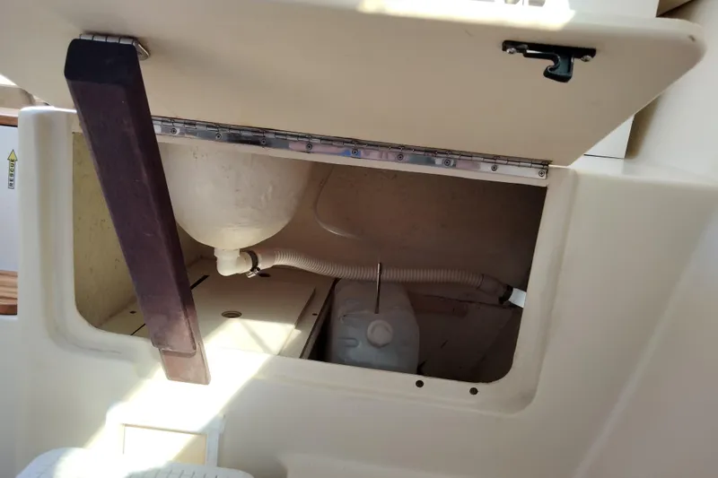 Slide: The Image of Open storage compartment on a 1998 Hunter 240 sailboat, showing interior components. - 6