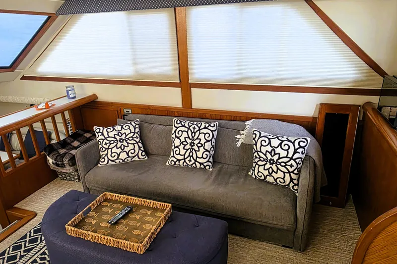 Slide: The Image of Luxurious interior of 1990 Californian 48 Cockpit Motor Yacht with cozy seating and decorative pillows. - 13