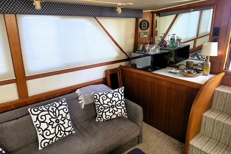 Slide: The Image of Interior of 1990 Californian 48 Cockpit Motor Yacht with cozy seating and bar area. - 14