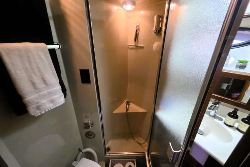 Slide: The Image of Bathroom interior of 1990 Californian 48 Cockpit Motor Yacht with shower and amenities. - 28
