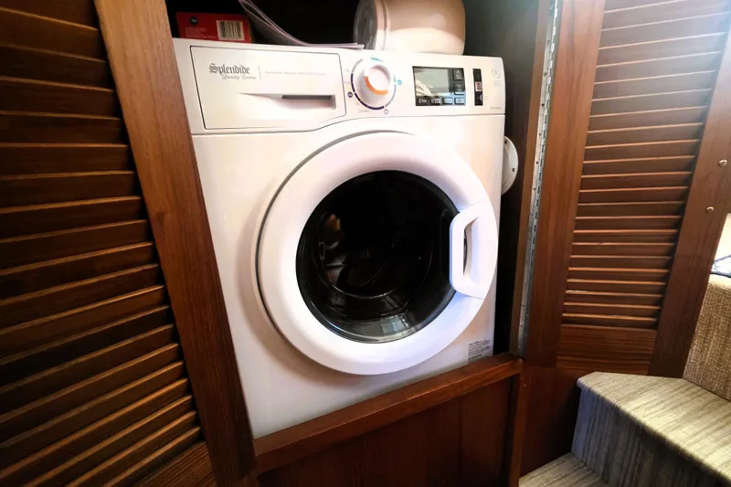 Slide: The Image of Washing machine in 1990 Californian 48 Cockpit Motor Yacht interior, wooden cabinetry. - 31