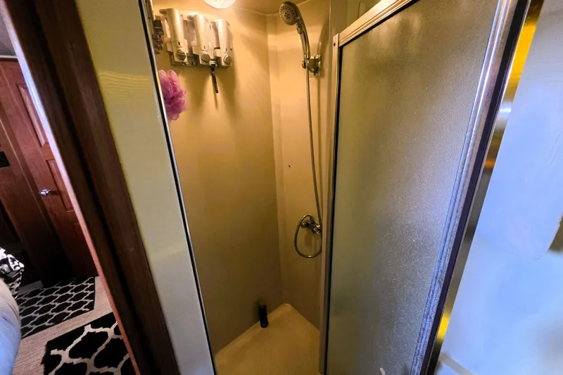 Slide: The Image of Shower area in 1990 Californian 48 Cockpit Motor Yacht with dispensers and handheld showerhead. - 37