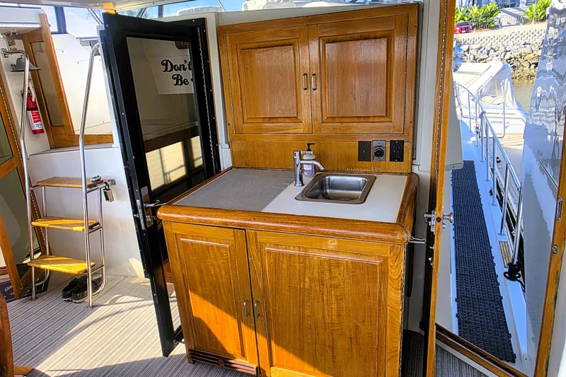 Slide: The Image of 1990 Californian 48 Cockpit Motor Yacht interior with wooden cabinetry and sink. - 4