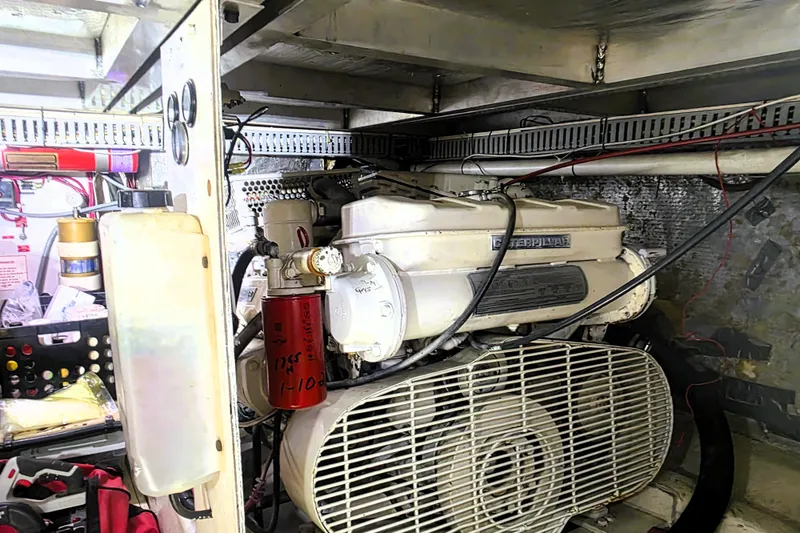 Slide: The Image of Engine room of a 1990 Californian 48 Cockpit Motor Yacht, showcasing mechanical components. - 48