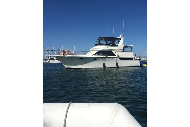 Slide: The Image of 1990 Californian 48 Cockpit Motor Yacht on calm water, clear sky background. - 61