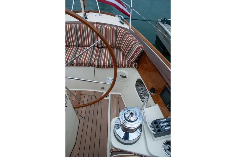 Slide: The Image of Cockpit of 2011 Morris M42 sailboat with striped cushions and wooden steering wheel. - 10