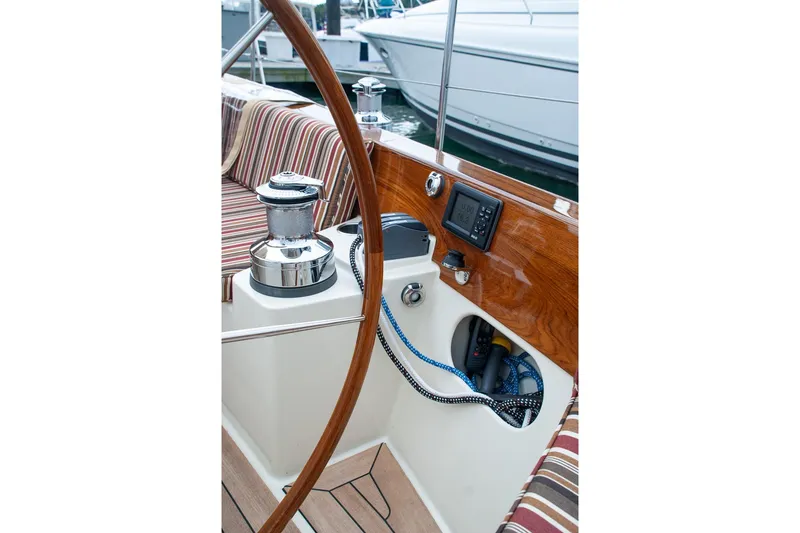 Slide: The Image of Cockpit of 2011 Morris M42 sailboat with striped seating and navigation equipment. - 12