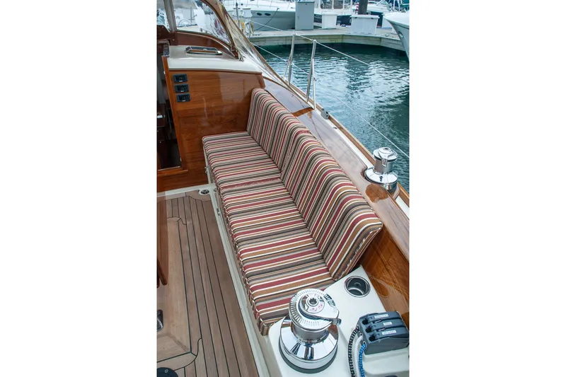 Slide: The Image of Striped cushioned seating on a 2011 Morris M42 yacht deck, with polished wood and nautical equipment. - 13
