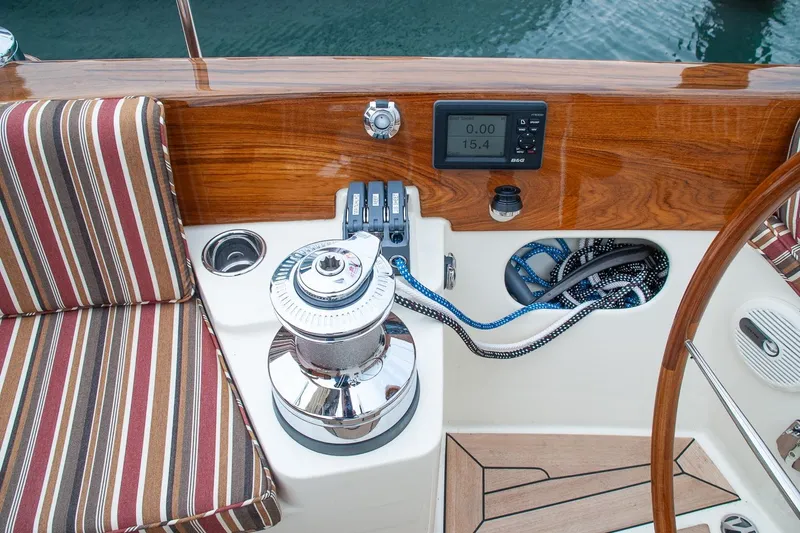 Slide: The Image of Cockpit of 2011 Morris M42 sailboat with striped seating, winch, and navigation controls. - 14