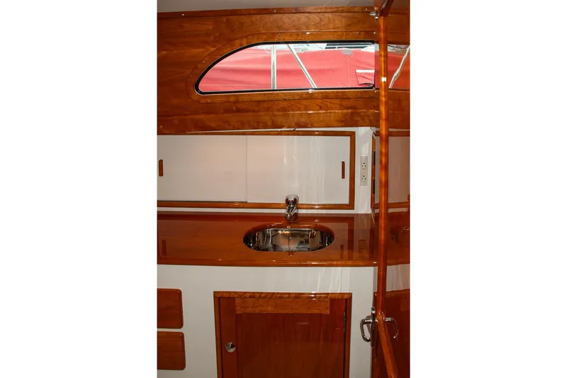Slide: The Image of Interior of 2011 Morris M42 yacht featuring polished wood cabinetry and a sleek sink. - 19