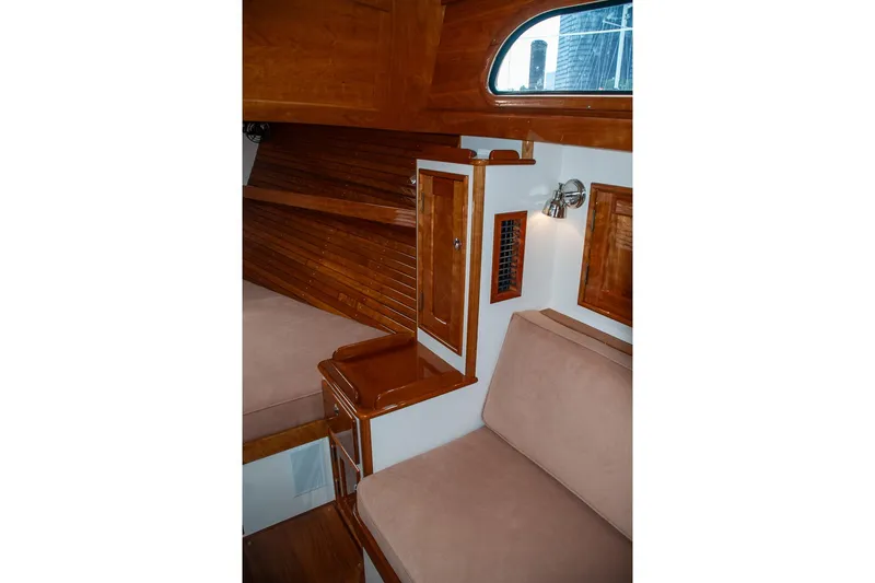 Slide: The Image of Interior of 2011 Morris M42 sailboat with wooden paneling and cozy seating area. - 23