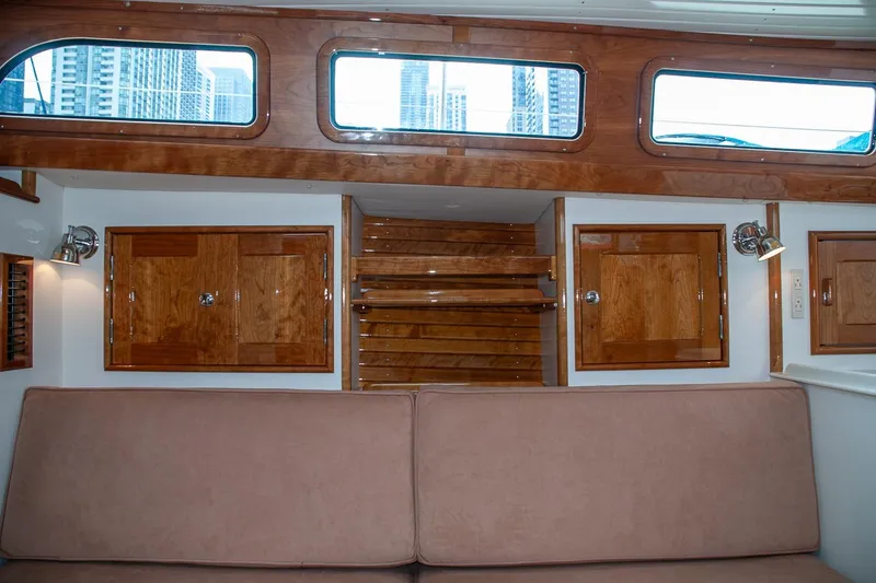 Slide: The Image of Interior of a 2011 Morris M42 yacht with wooden cabinetry and beige seating. - 24