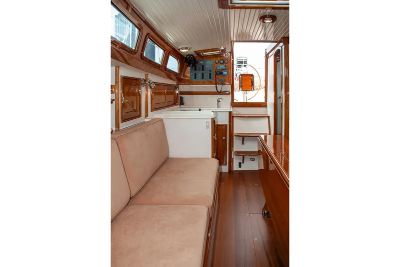 Slide: The Image of Interior of 2011 Morris M42 sailboat with wooden finishes and beige seating. - 30