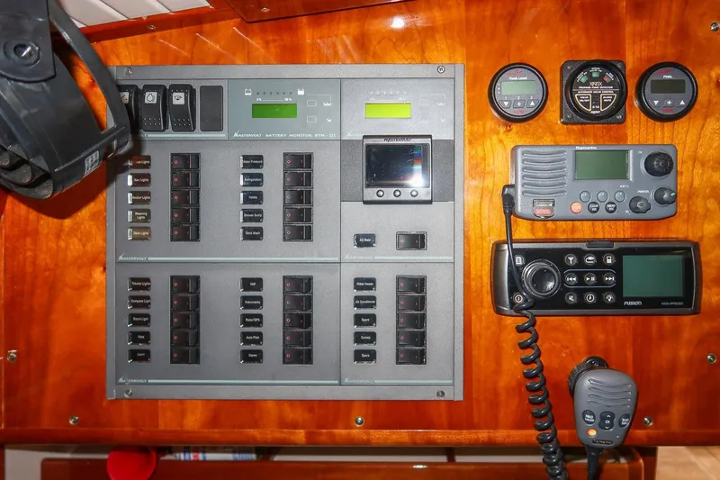 Slide: The Image of Electrical control panel on a 2011 Morris M42 yacht, featuring various switches and communication devices. - 33
