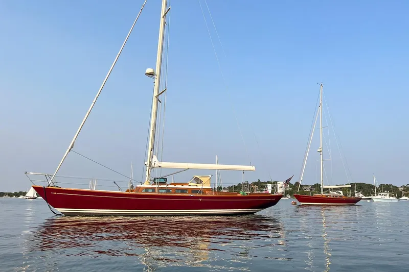 Slide: The Image of Red Morris M42 sailboats on calm water, clear sky, 2011 model. - 4