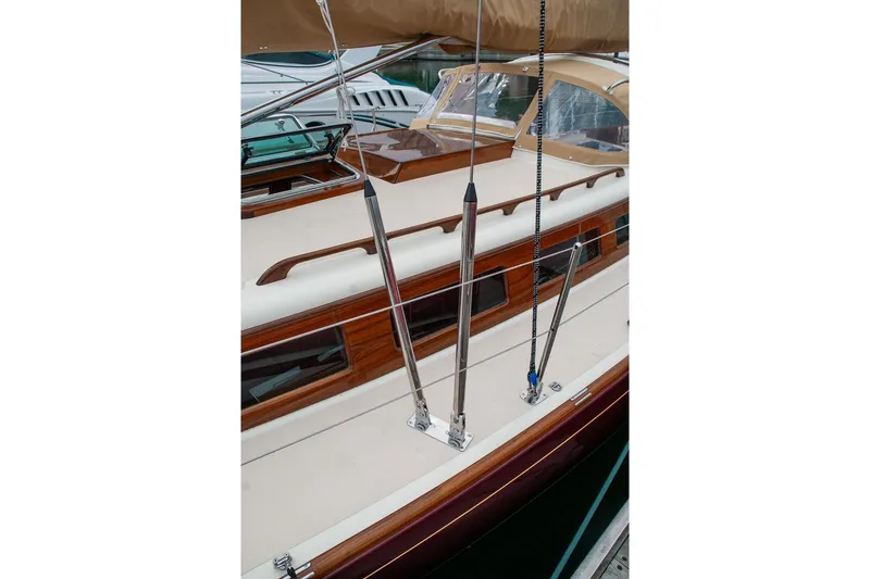 Slide: The Image of Deck view of a 2011 Morris M42 sailboat with polished wood and stainless steel fittings. - 7