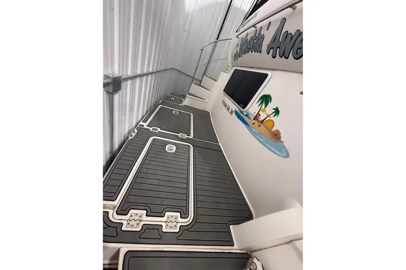 Slide: The Image of 2005 Cruisers Yachts 405 Express Motoryacht with custom deck and tropical-themed graphics. - 10