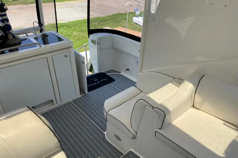 Slide: The Image of 2005 Cruisers Yachts 405 Express Motoryacht interior with white seating and kitchenette. - 14