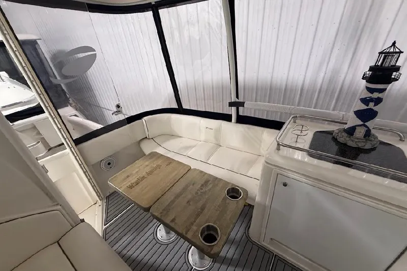 Slide: The Image of 2005 Cruisers Yachts 405 Express Motoryacht interior with seating, table, and nautical decor. - 15