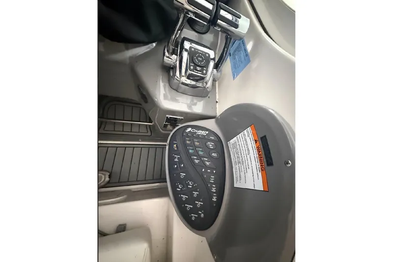 Slide: The Image of Control panel of a 2005 Cruisers Yachts 405 Express Motoryacht, featuring navigation and throttle controls. - 21