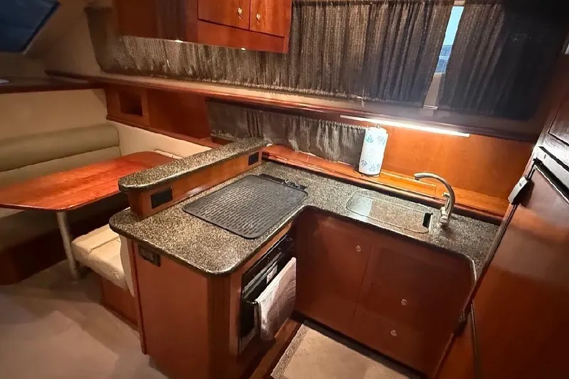 Slide: The Image of Luxurious 2005 Cruisers Yachts 405 Express Motoryacht interior kitchen with granite countertops. - 25