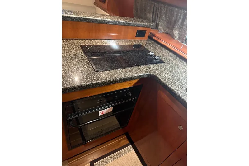 Slide: The Image of Luxurious kitchen area in 2005 Cruisers Yachts 405 Express Motoryacht with granite countertops. - 26