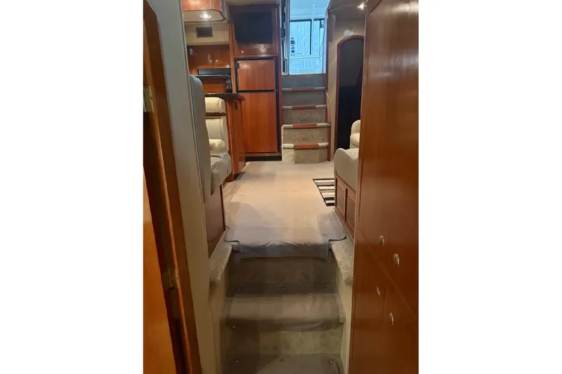 Slide: The Image of Interior of 2005 Cruisers Yachts 405 Express Motoryacht, featuring cozy seating and wooden cabinetry. - 28