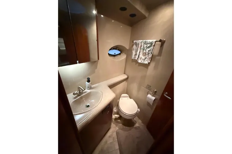 Slide: The Image of Luxurious bathroom in 2005 Cruisers Yachts 405 Express Motoryacht with sink and toilet. - 38