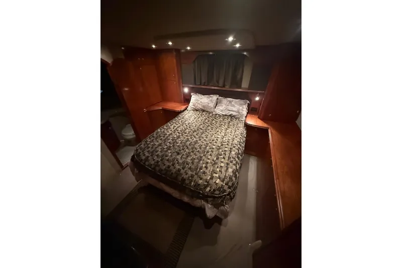 Slide: The Image of Luxurious bedroom interior of 2005 Cruisers Yachts 405 Express Motoryacht with cozy lighting. - 42