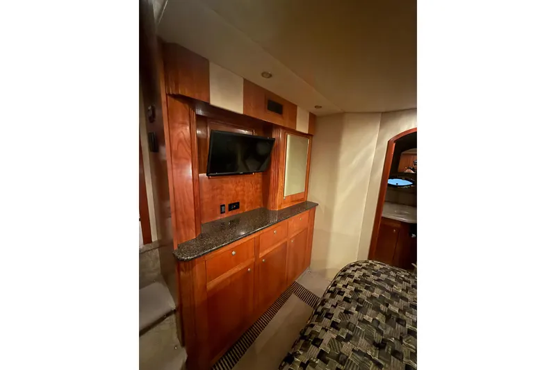 Slide: The Image of Luxurious 2005 Cruisers Yachts 405 Express Motoryacht interior with wood cabinetry and TV. - 44