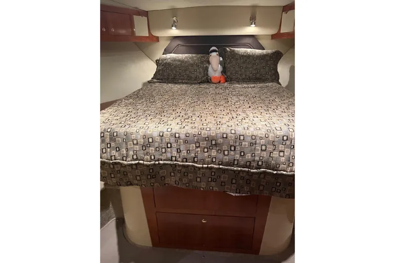 Slide: The Image of Luxurious bedroom in 2005 Cruisers Yachts 405 Express Motoryacht with plush bedding and cozy lighting. - 50