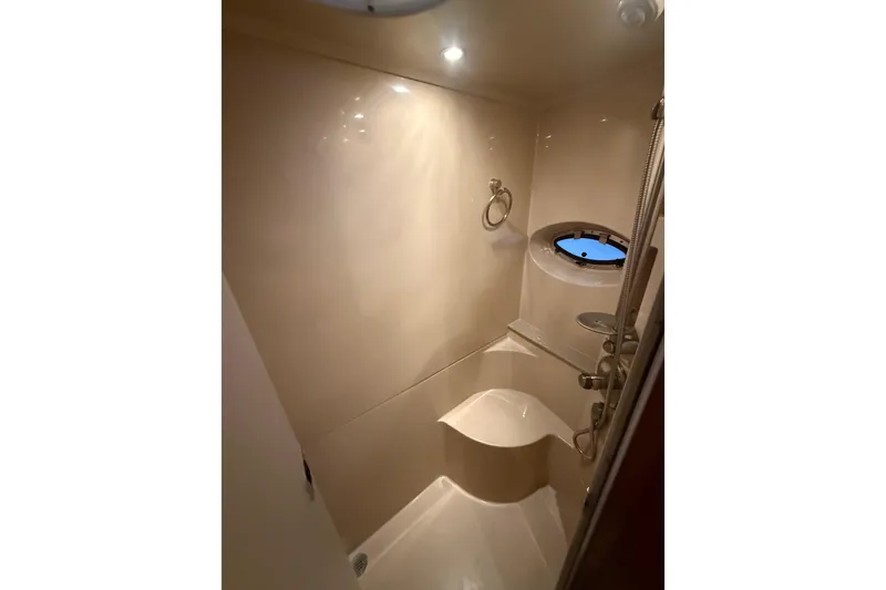 Slide: The Image of 2005 Cruisers Yachts 405 Express Motoryacht bathroom with shower and porthole window. - 57